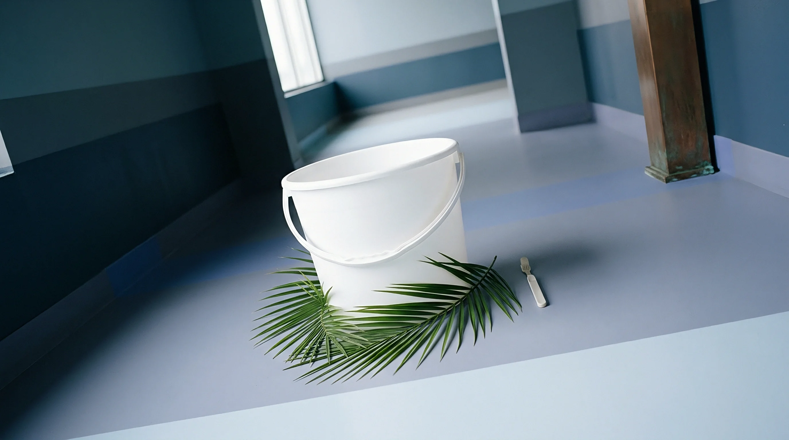 A digital render shows a white injection moulded polypropylene bucket and a plastic fork resting on a smooth grey indoor floor.