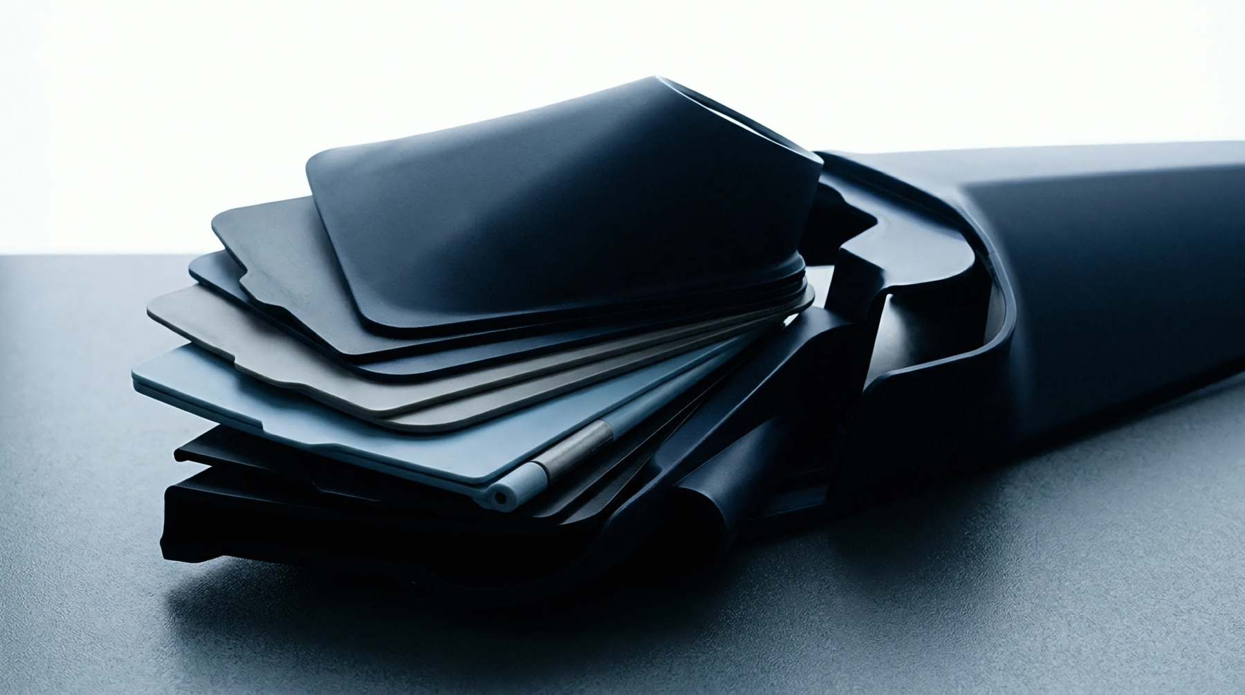 Multiple thermoplastic resin color samples in sheet form are arranged in a tiered stack within a custom injection molded storage casing.