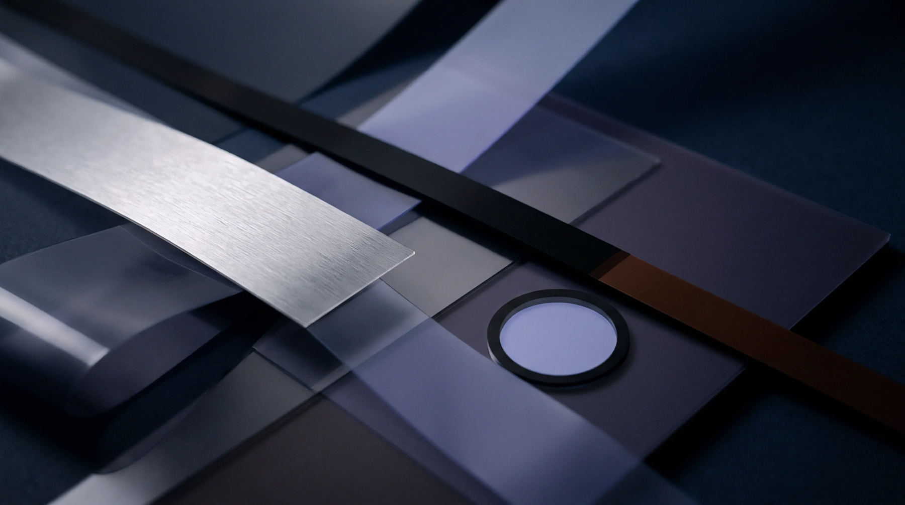 Translucent polymer ribbons intersect with a brushed aluminum strip and a circular moulded optical component in an abstract graphic industrial setting.